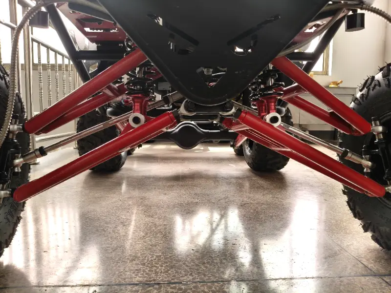 Adult electric off-road buggy side view with off-road tires and suspension system
